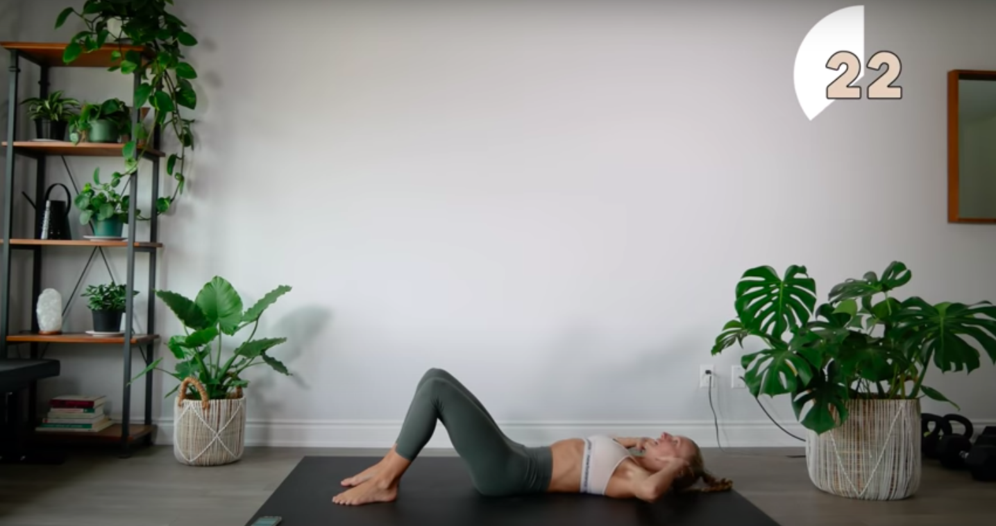 a woman is doing a yoga pose on a mat