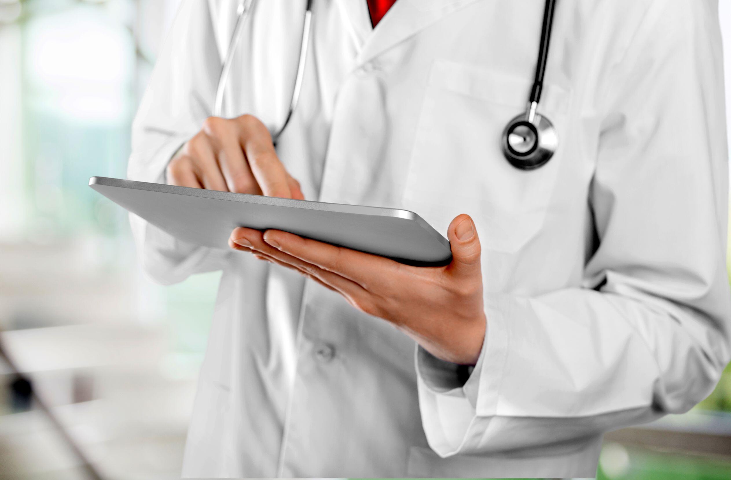 a doctor is using a tablet computer